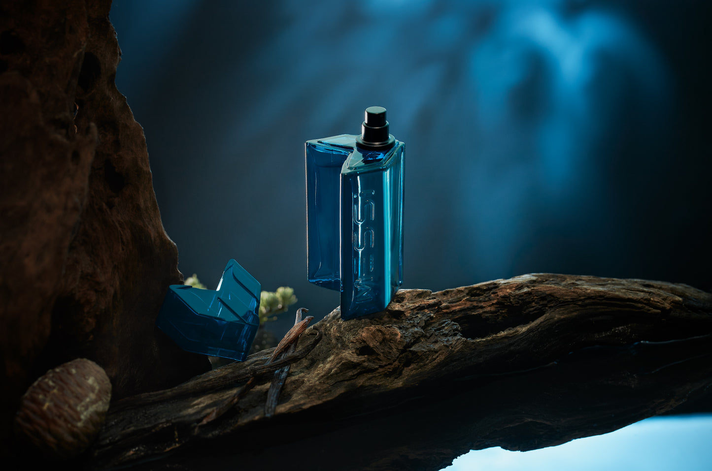 Messi Eau de Parfum bottle resting on a tree branch, surrounded by nature with a deep blue background.